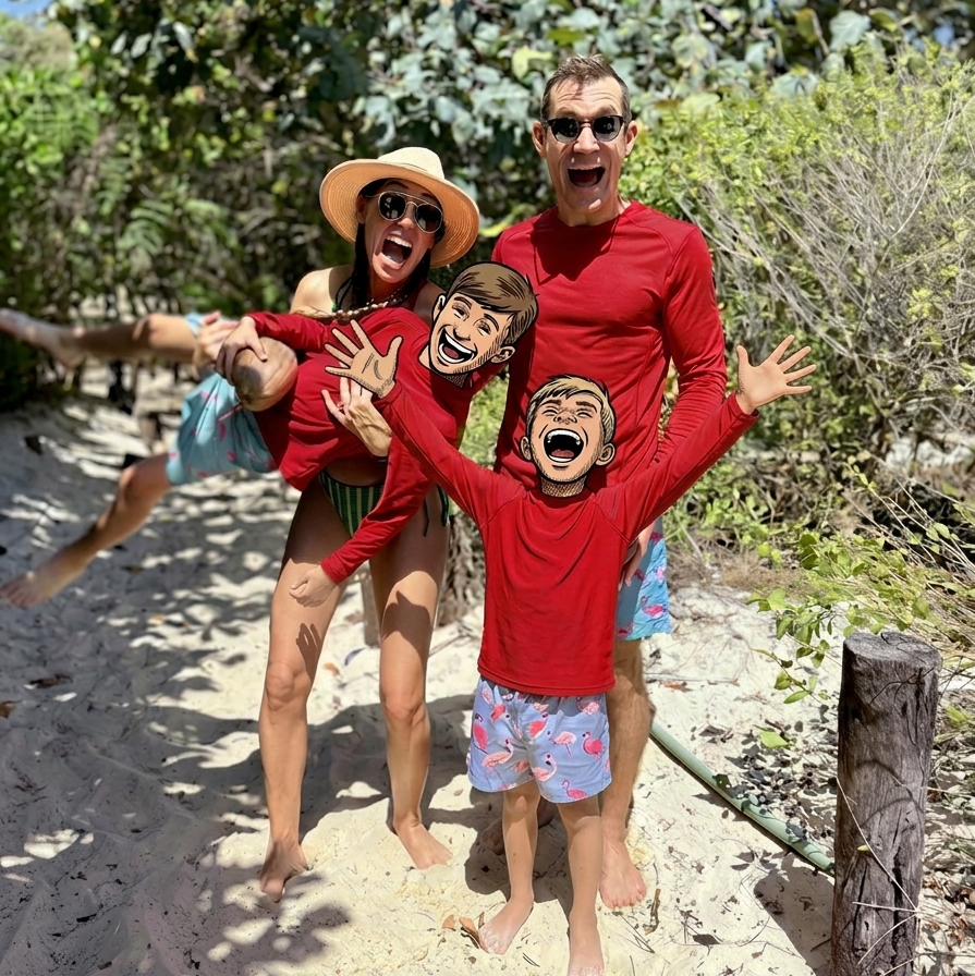 Dr. Derman, his wife, and his two young sons posing together on the beach with greenery in the background.