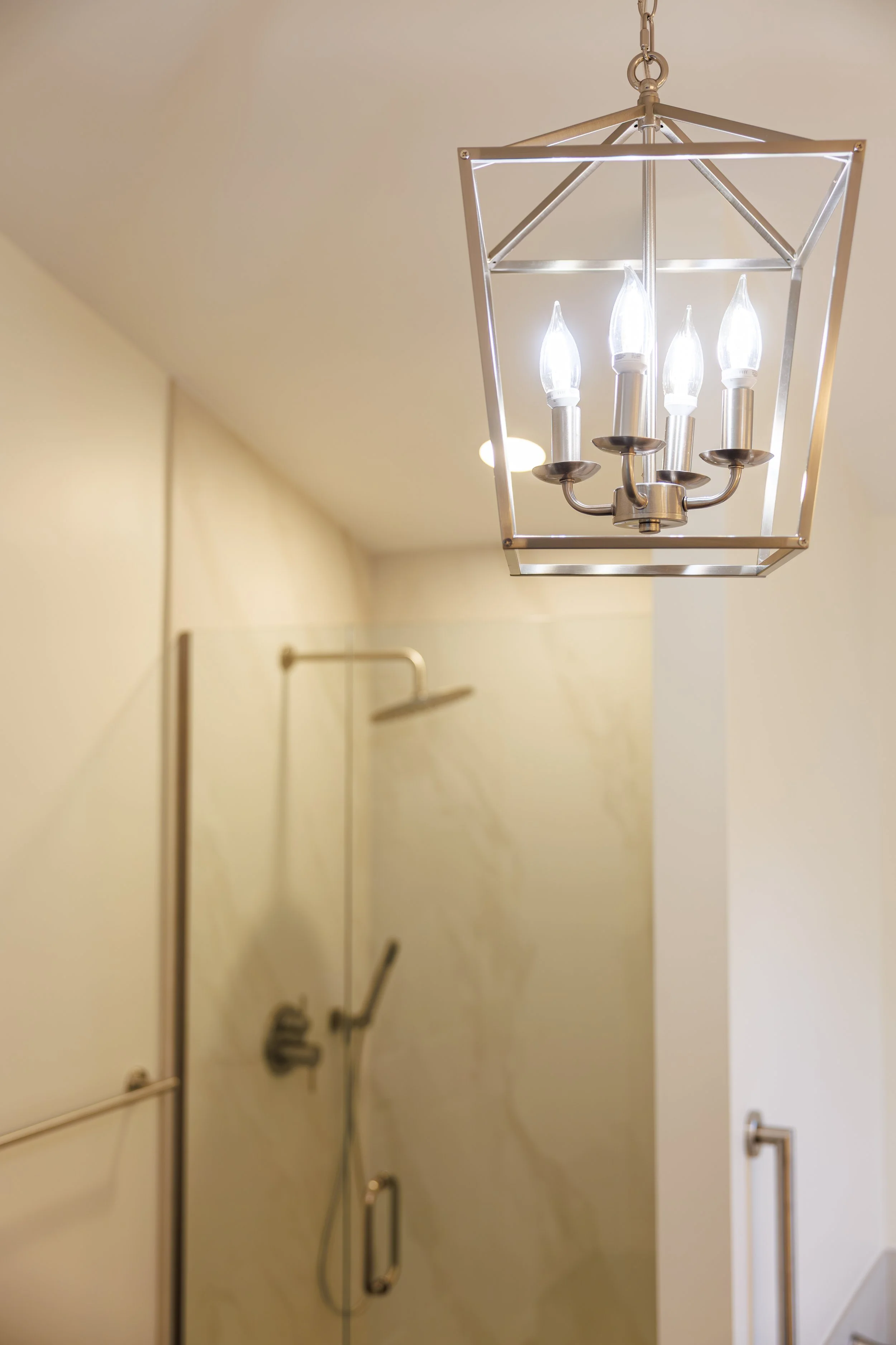 luxury-bathroom-remodel-glass-shower-chandelier.jpg