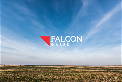 Open sky over a flat open field with a Falcon Gases logo in the center.