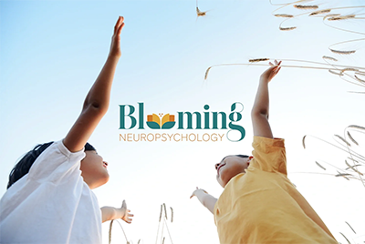 Two children reaching toward the sky among tall grasses, with the word 'Blooming' and 'Neuropsychology' written on the image.