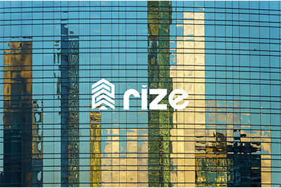 Reflected skyscrapers on a glass building facade with the Rize logo in the center.