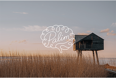 A wooden house on stilts in a grassy marshland at sunset with a cloudy sky and a speech bubble with the word 'Palm' inside.