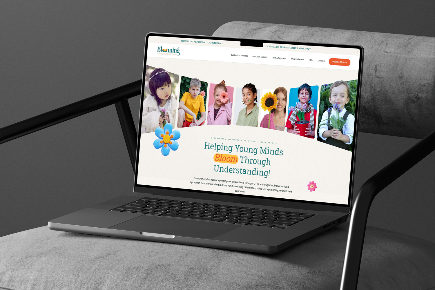 Laptop on a desk displaying a website for Bloom Neuropsychology with photos of children, some holding flowers, and text about helping young minds