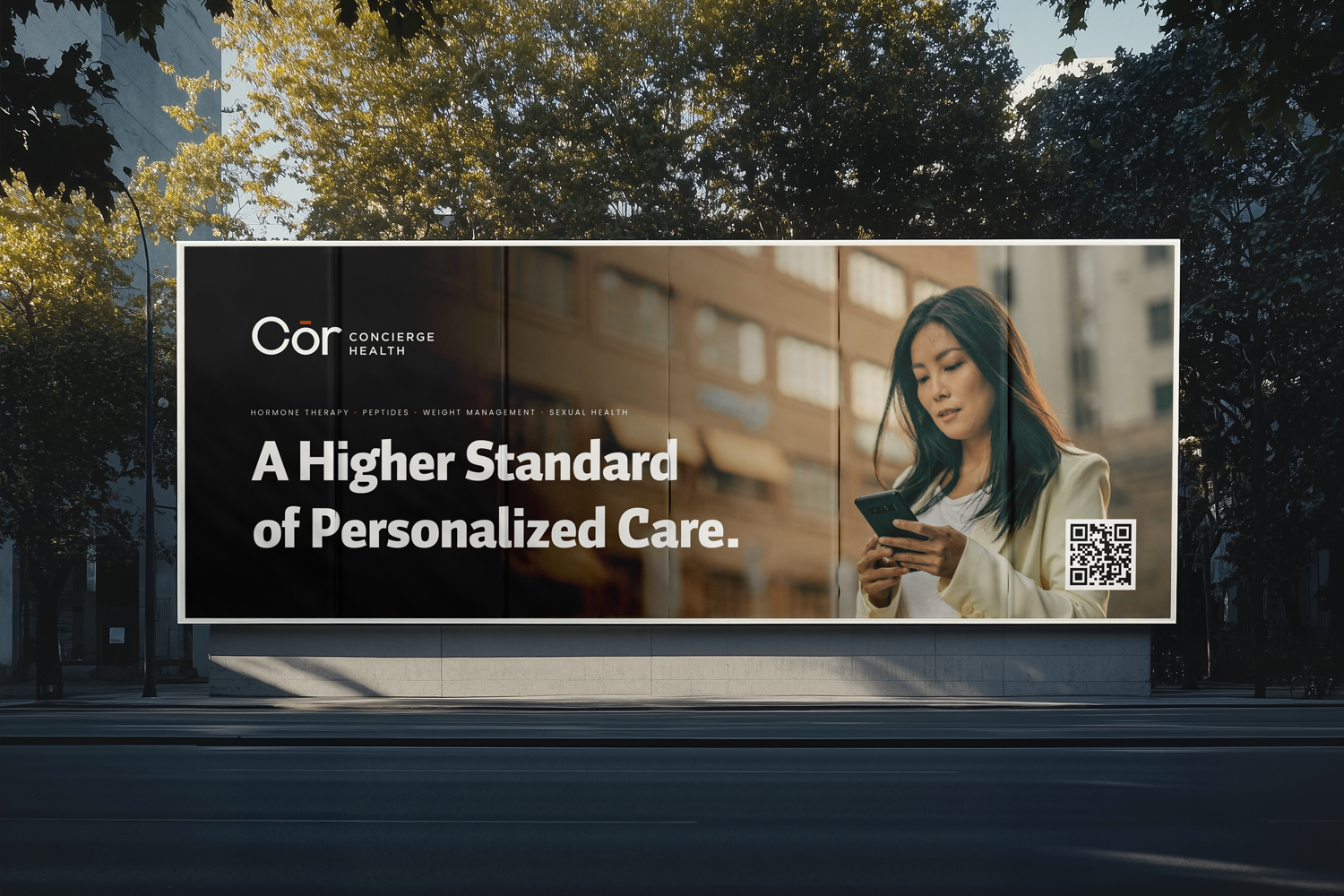 Billboard advertisement for Cor Concierge Health showing a woman looking at her phone, with the text 'A Higher Standard of Personalized Care' and a QR code.