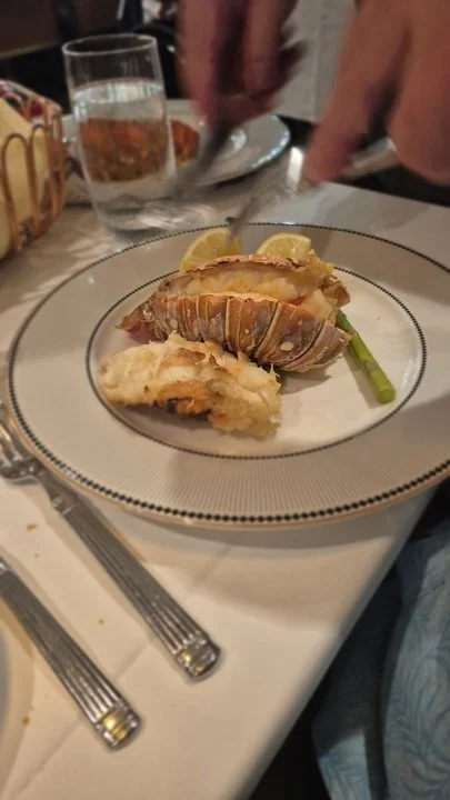 oven-baked lobster tail with a sun-dried tomato lemon pesto mash, roasted asparagus, and drawn butter at 1923 on the Disney Treasure