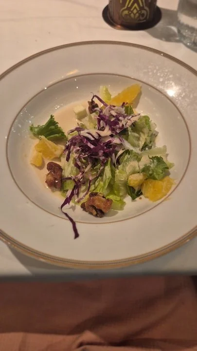 Belgian endive, radicchio, and escarole lettuce salad with brie cheese, Valencia orange, candied walnut, and aged sherry vinaigrette at 1923 on the Disney Treasure