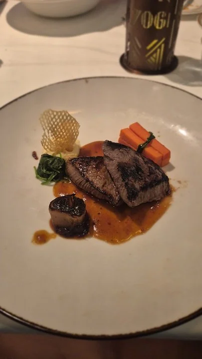 juniper marinated venison loin with tupelo honey parsnip purée, roasted shallots, heirloom carrots, game chips, and a Napa Valley port wine jus at 1923 on the Disney Treasure