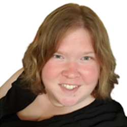 A young girl with shoulder-length light brown hair, smiling, wearing a black top.