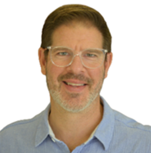 A middle-aged man with brown hair, glasses, and a beard, wearing a light blue shirt, smiling against a plain white background.