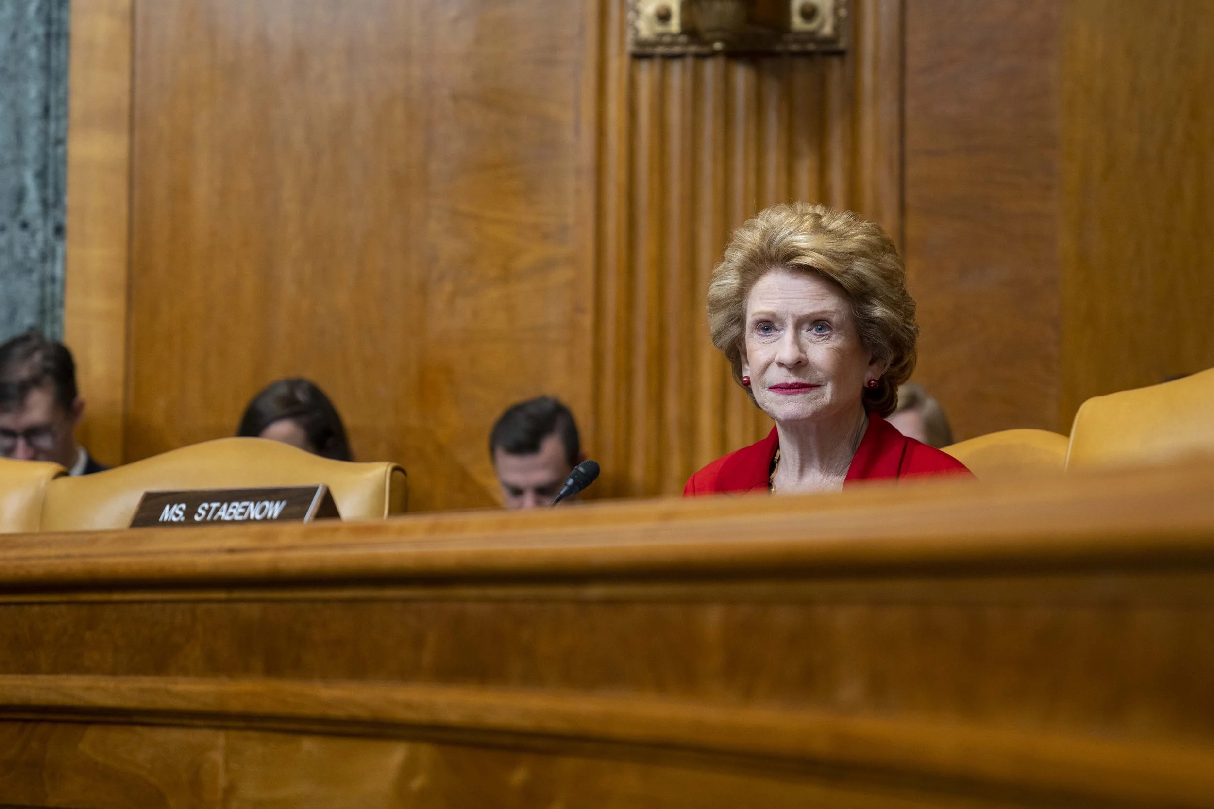 Sen. Debbie Stabenow watches from behind the dais at a senate committee hearing.