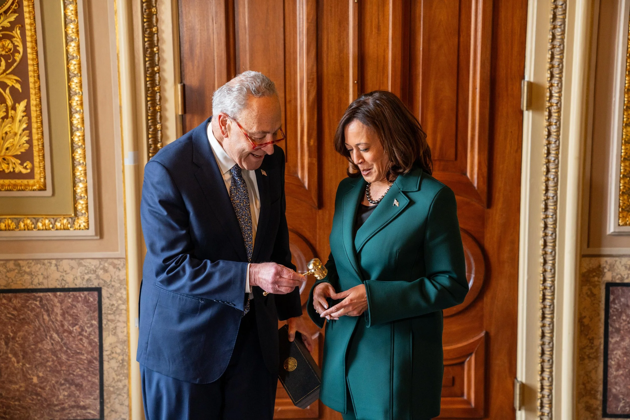 Chuck Schumer gives a Golden Gavel to Vice President Kamala Harris outside the Senate floor for her record-breaking Senate tiebreaker vote.