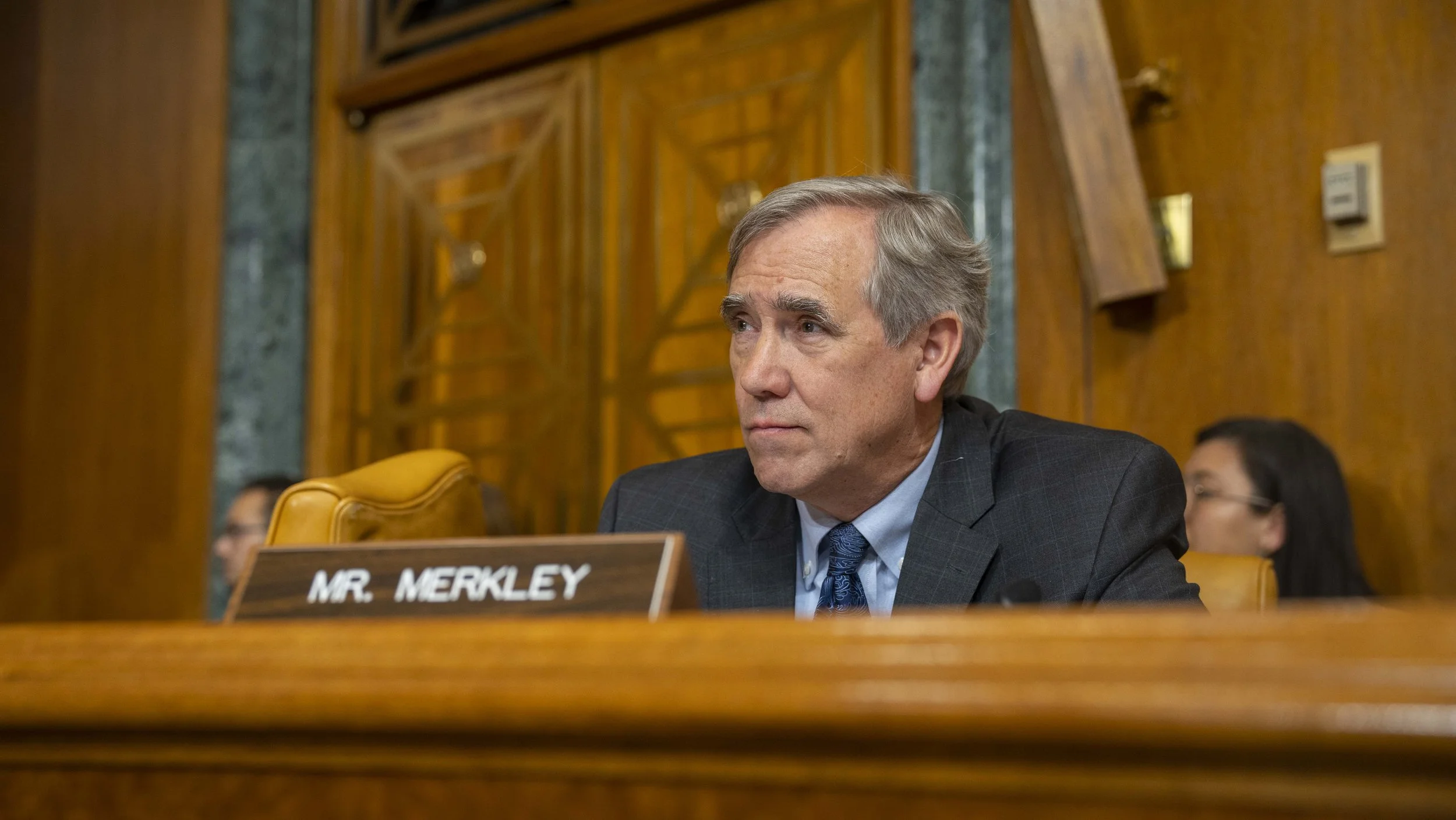 Sen. Jeff Merkley sits at a Senate hearing.