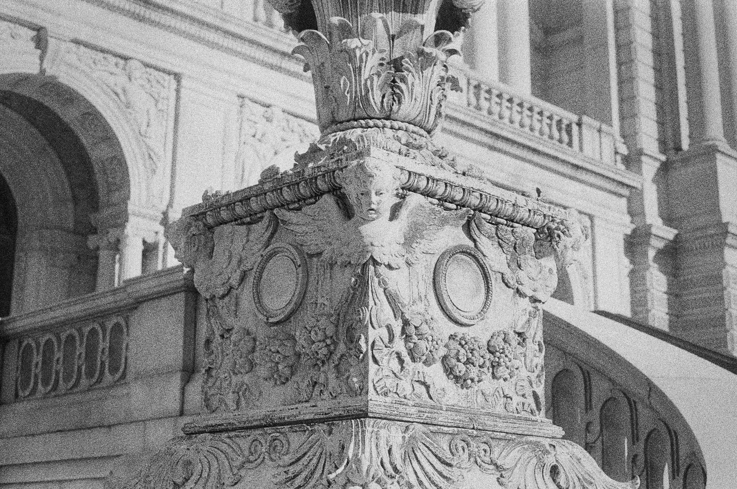 Close-up of ornate stone architectural details on the Library of Congress, including decorative sculptures and intricate carvings.