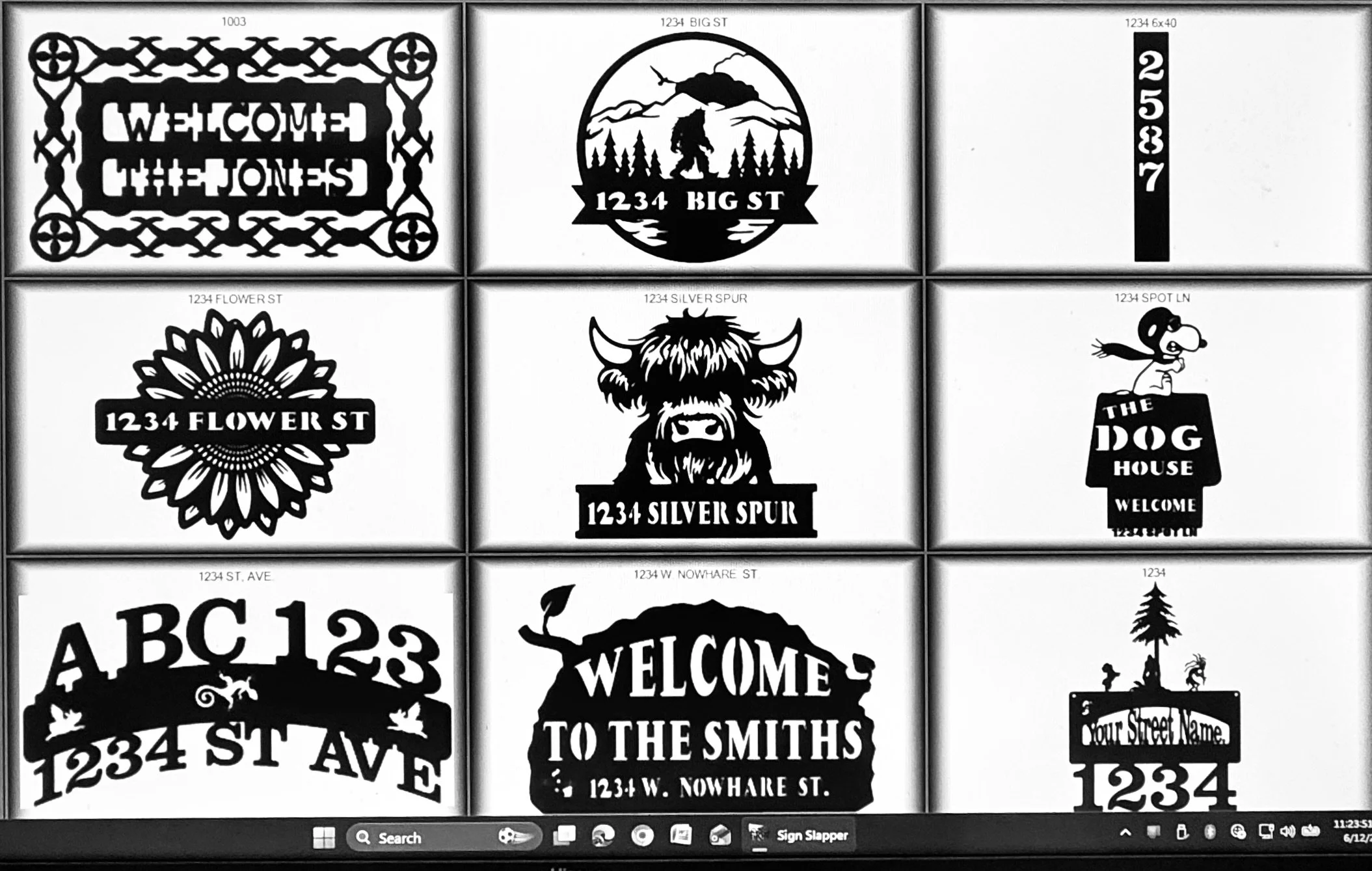 Collection of black and white silhouette signs and stickers with various welcome messages, address numbers, and decorative designs, including a mountain and forest scene, a dog, and floral patterns.