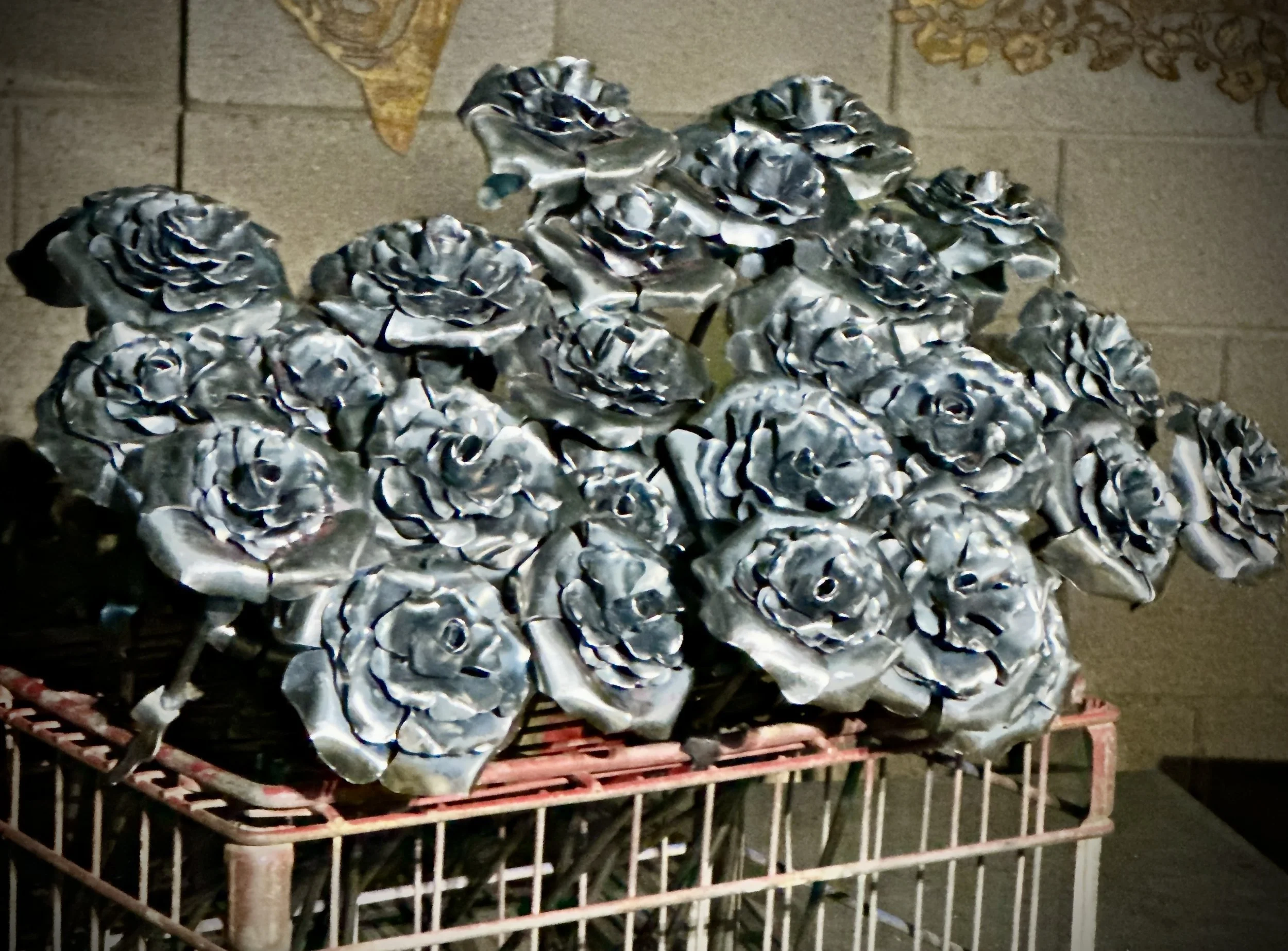 A pile of crumpled aluminum foil on a red wire cart in a possibly industrial or storage setting.