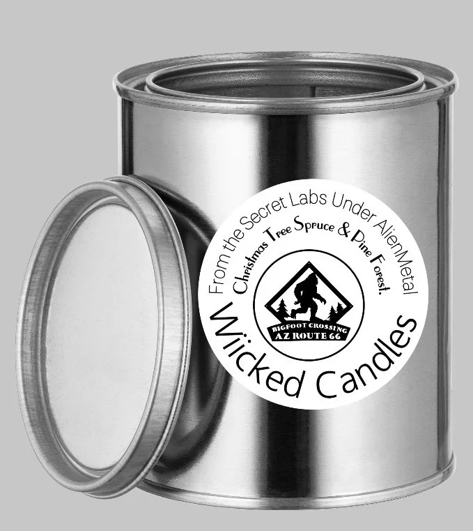 A metallic container with a removable lid, labeled as Wicked Candles with a logo of Bigfoot crossing sign, containing scented candles from secret labs under alien metal, Christmas tree spruce and pine forest scents.