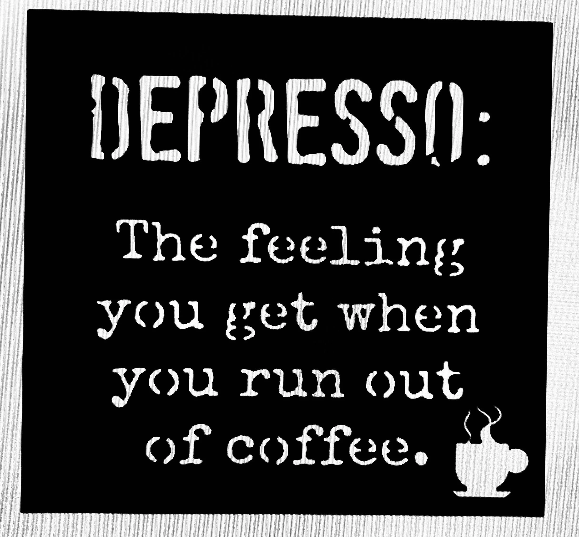 Black and white chalkboard sign with handwritten message about coffee.