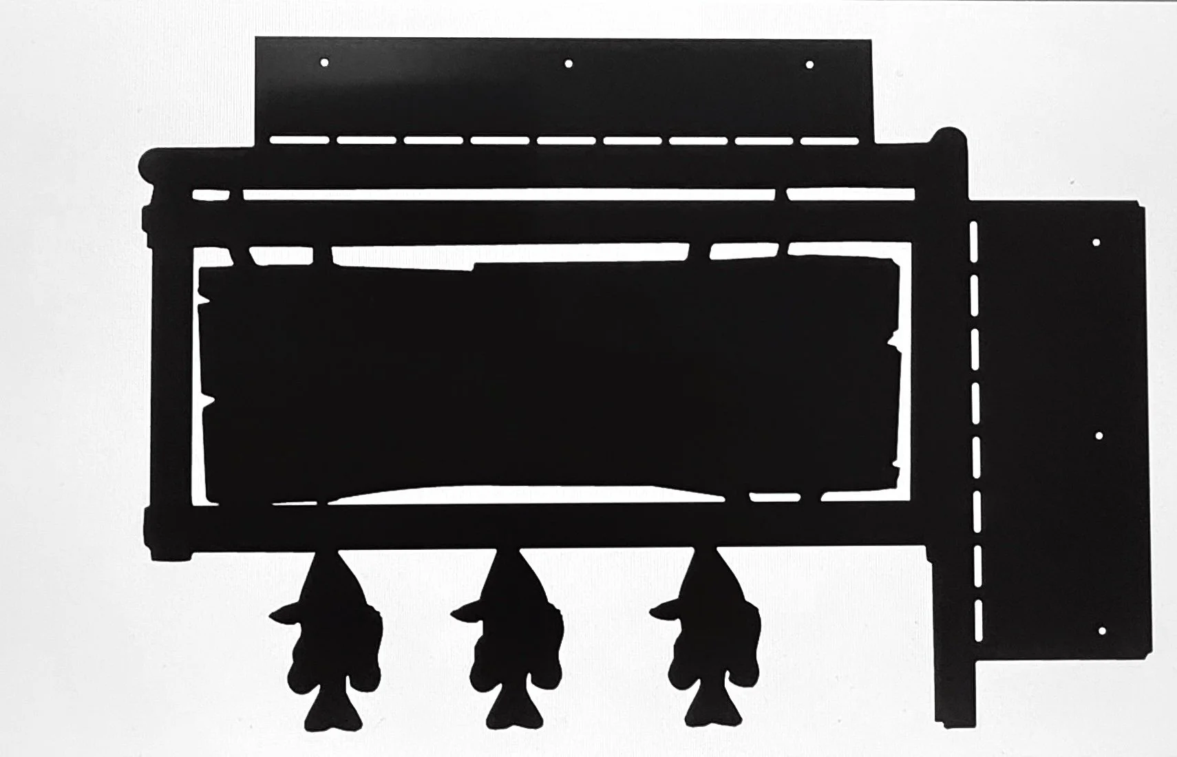 Silhouette of a built-in gas fireplace with a metal surround and glass front, with three logs inside and three log carriers beneath.