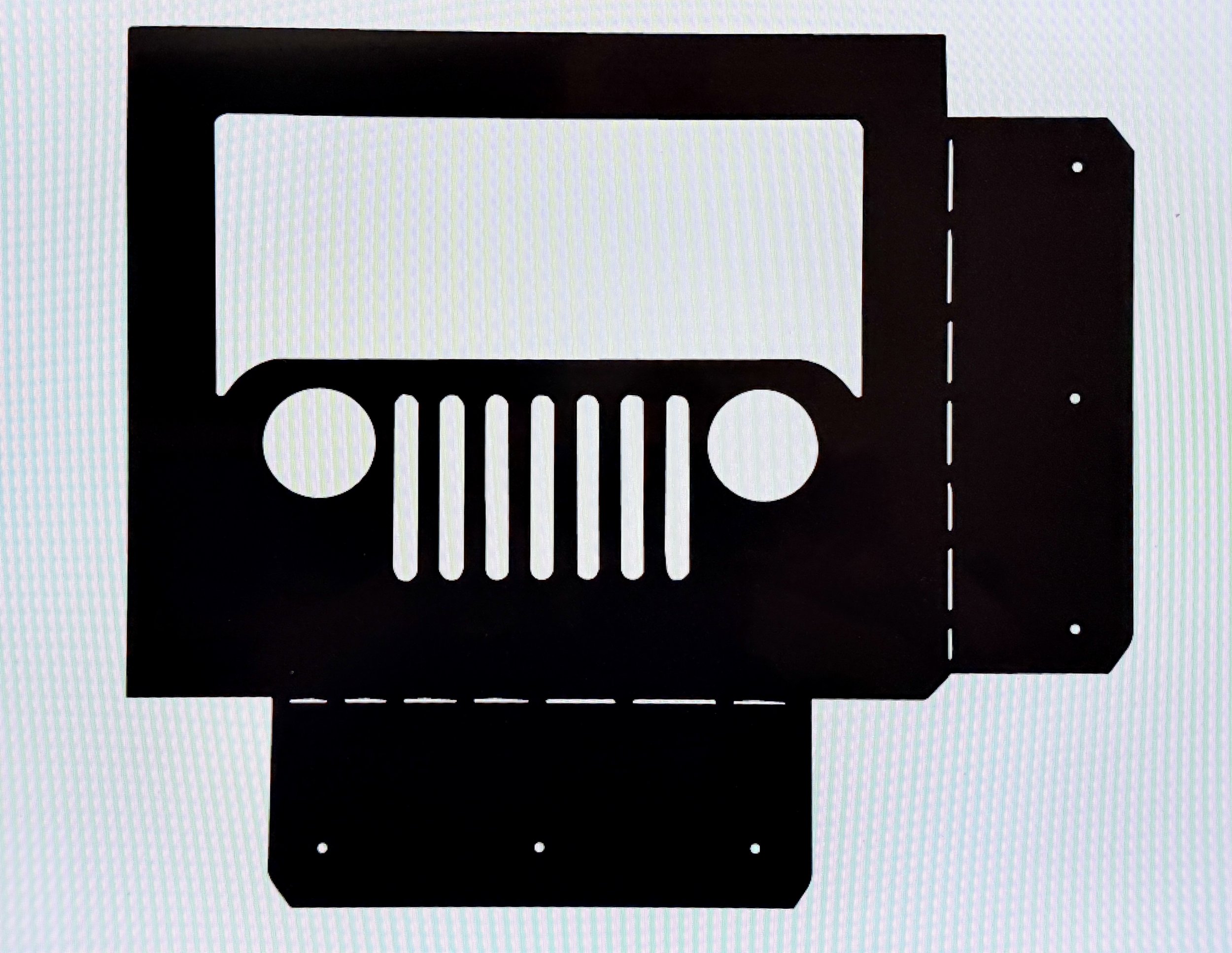 A black industrial razor blade with a white sticker in the center, viewed from above.