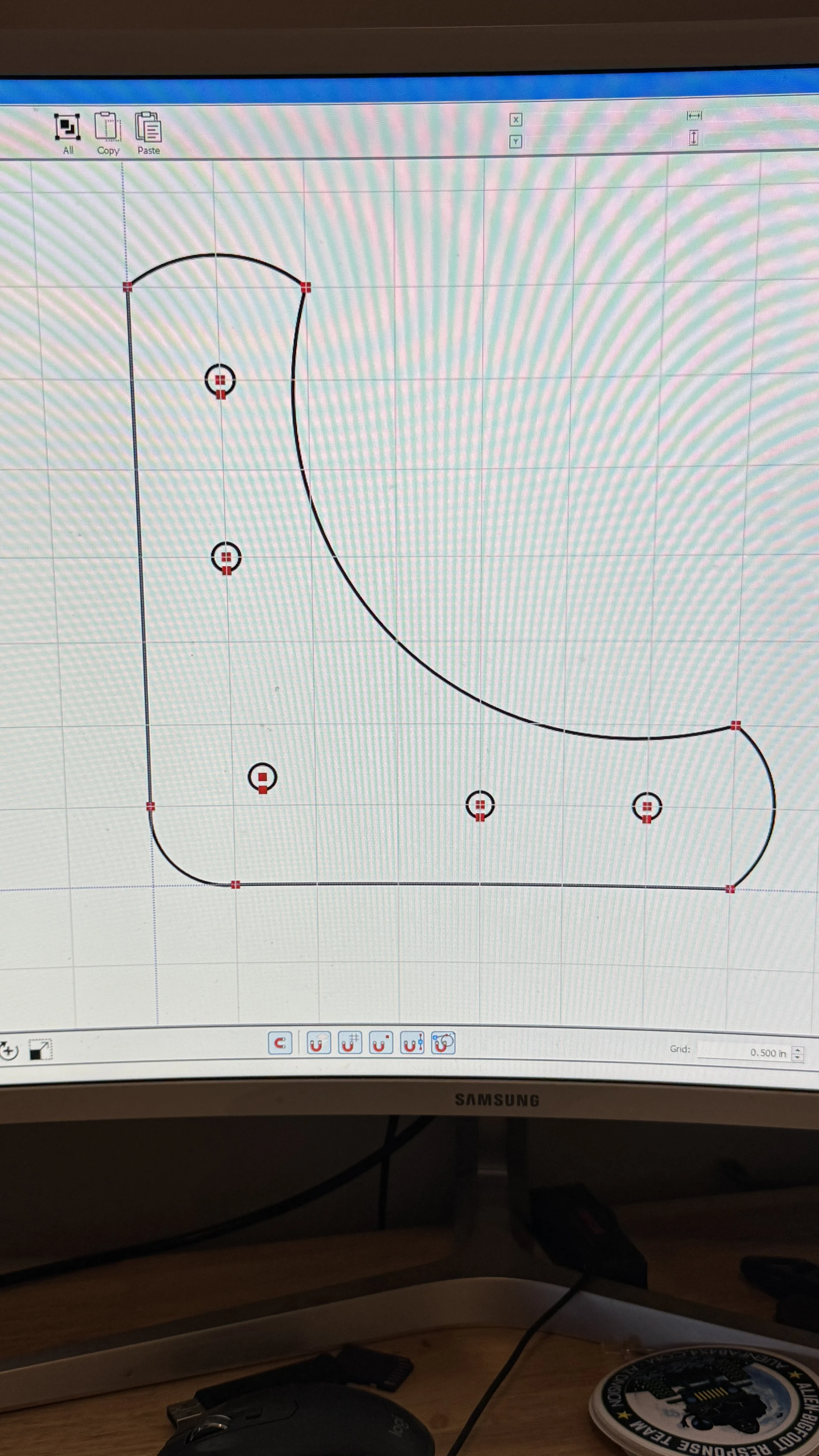 Computer screen displaying a design with black curved lines, red markers, and some grid lines, likely part of a CAD or design software interface.