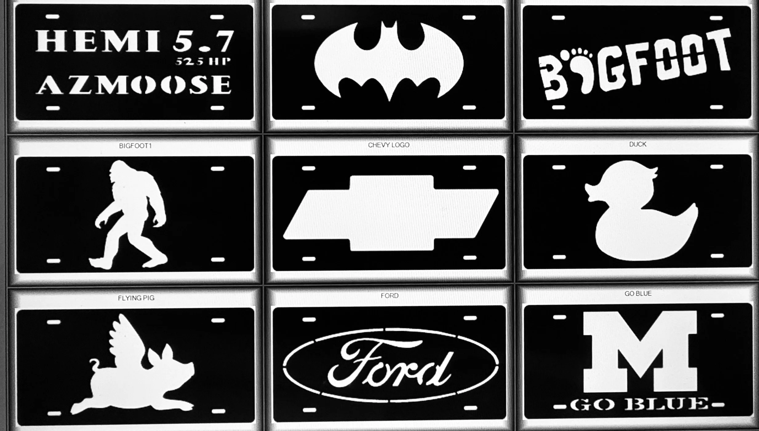 Black and white image of three rows of car license plates with various designs and logos, including texts like "HEMI 5.7", "AZMOOSE", the Batman logo, and the Ford logo.