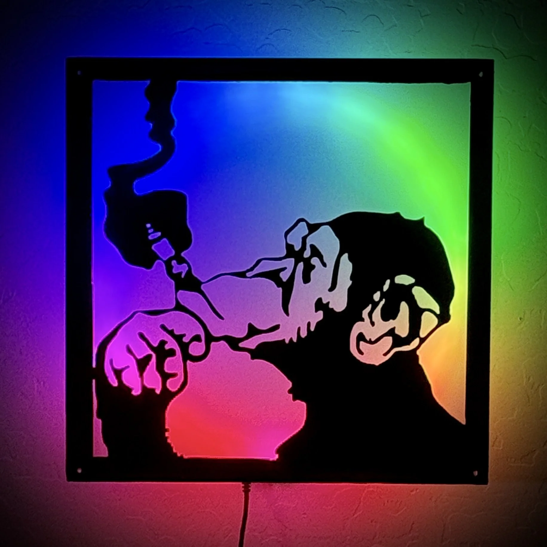 Colorful art piece of the human brain in black silhouette with vibrant rainbow gradient background
