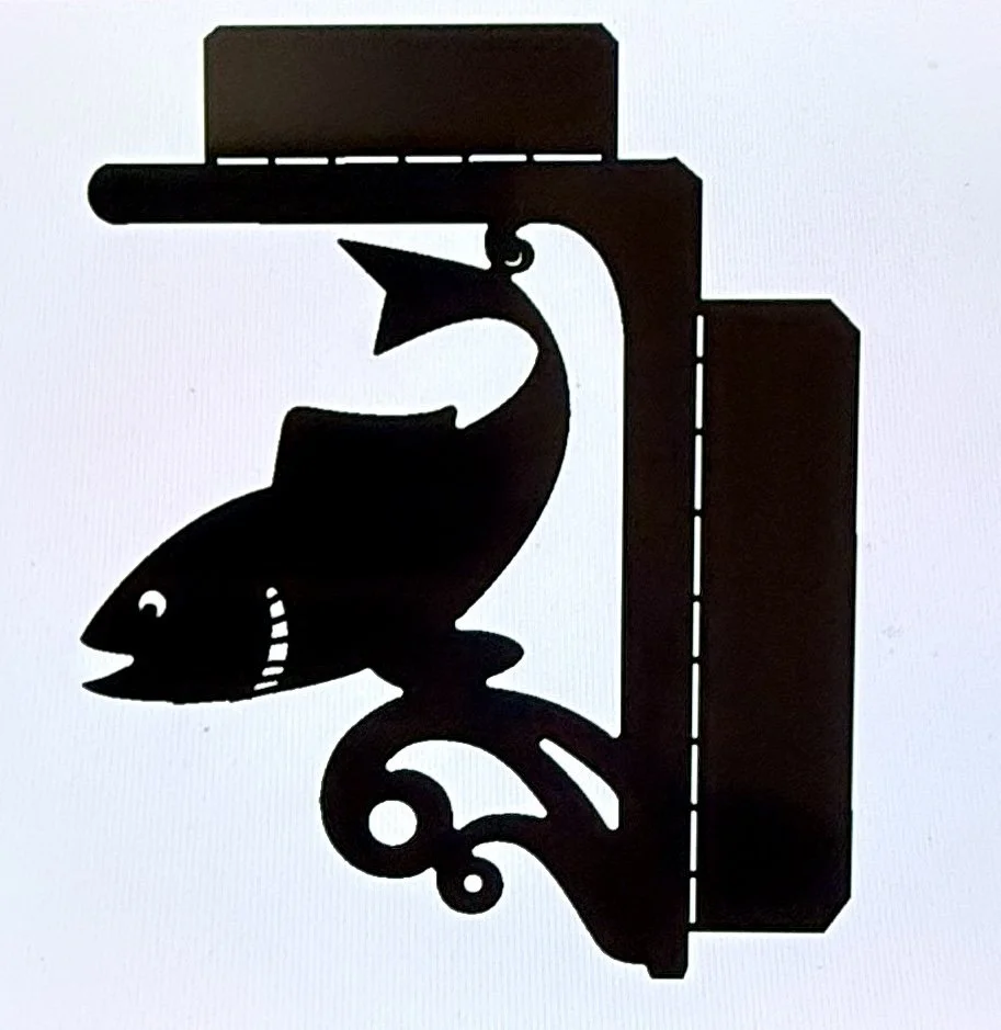 Silhouette of a fish mounted on a decorative bracket.