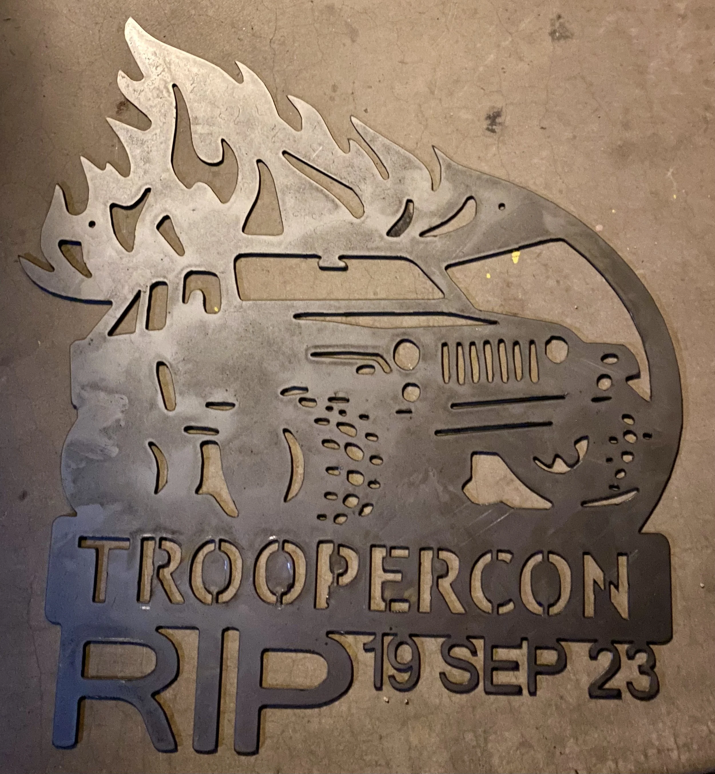 A metal laser-cut sign with the shape of a monstera leaf and text that reads: "Do you see the bigger picture?"
