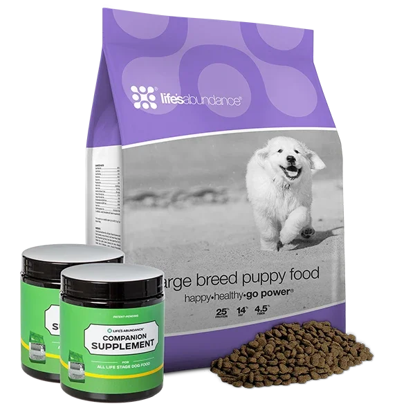 A purple bag of large breed puppy food, two containers of dog supplement, and a small pile of dog kibble in front of the bag.