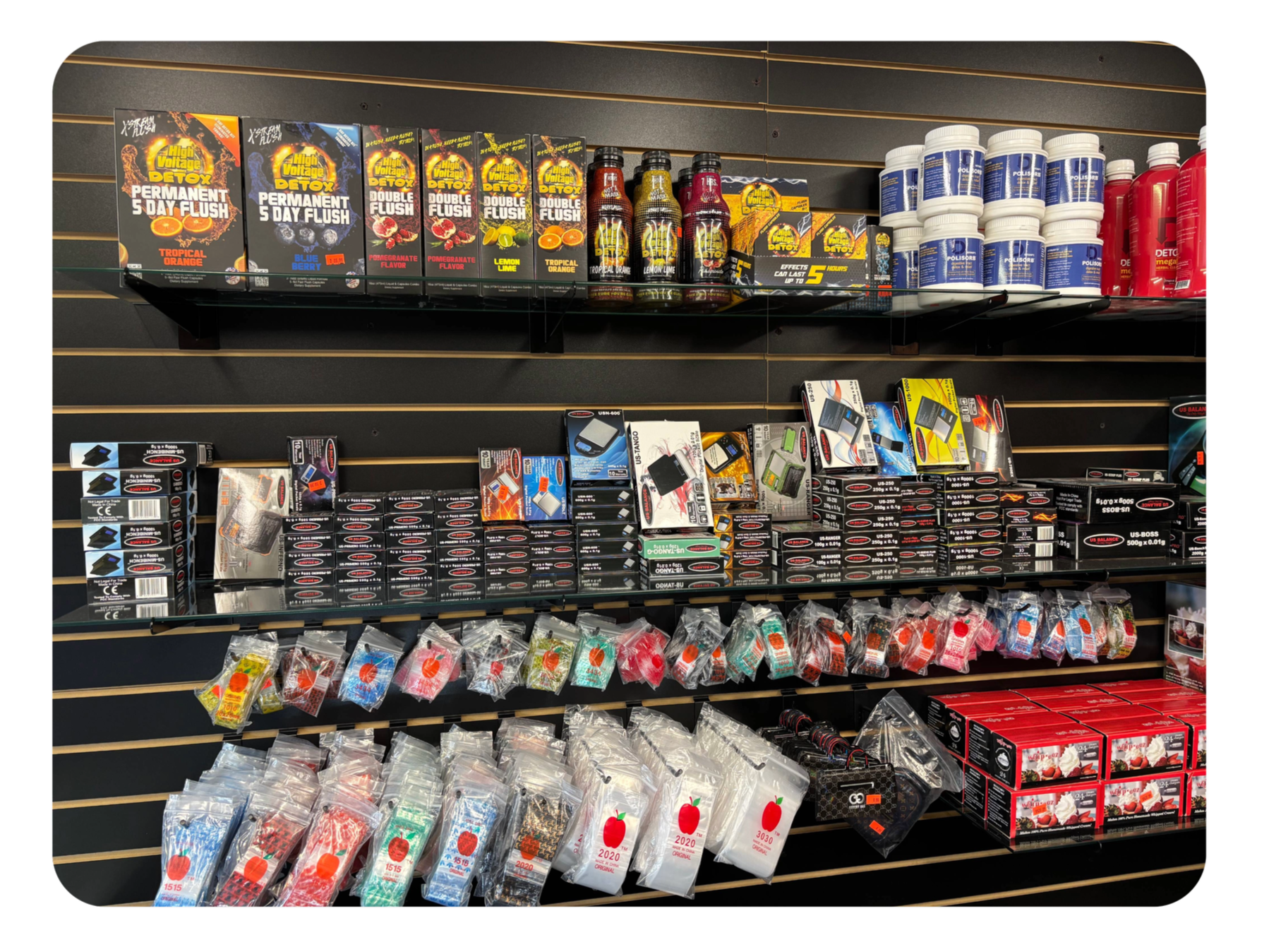 Shelf in a store with health and beauty products including detox drinks, skincare items, and packaged candy.