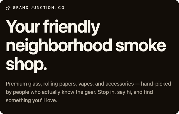 Sign for a neighborhood smoke shop in Grand Junction, CO, advertising glass, rolling papers, vapes, and accessories with friendly, inviting text.