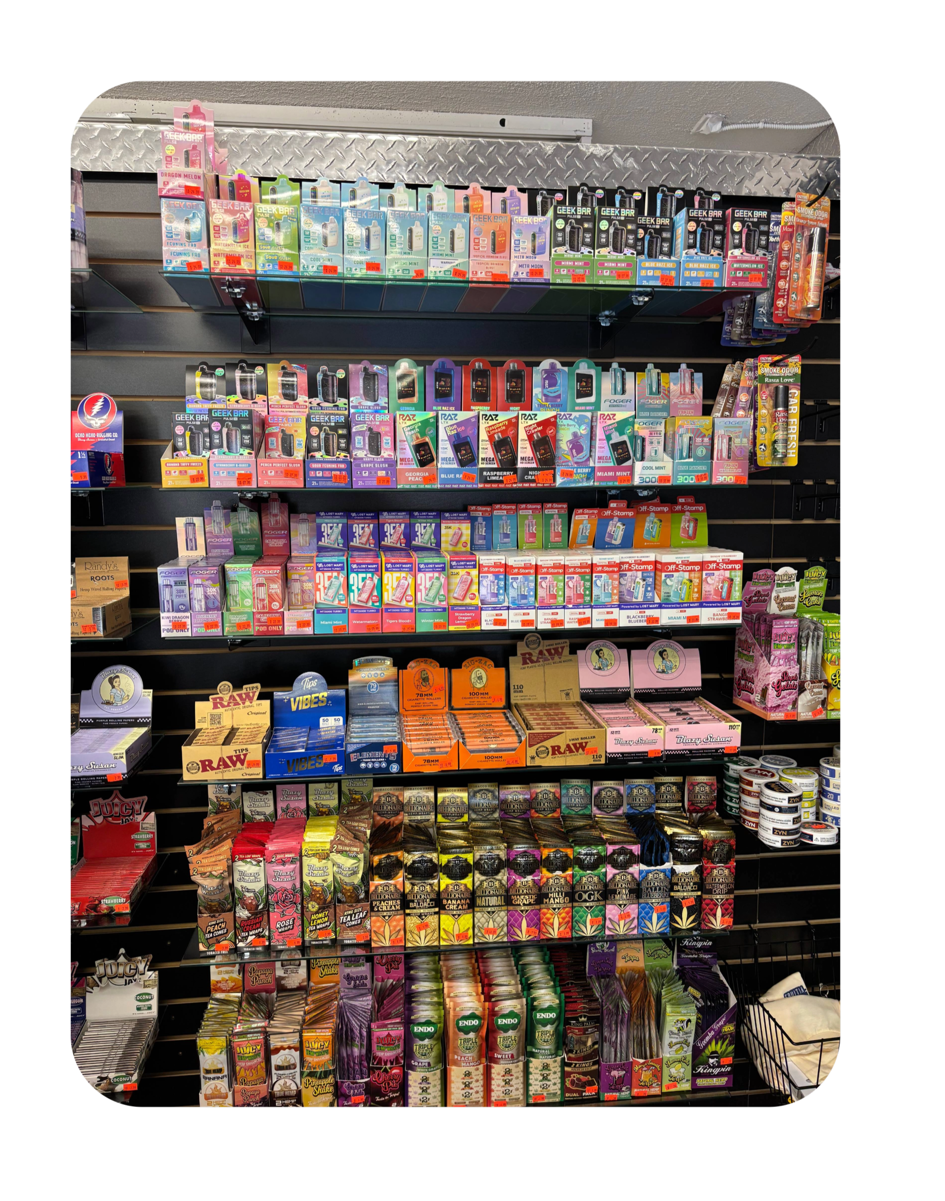 Display of flavored vape juices on store shelves in various colorful boxes.