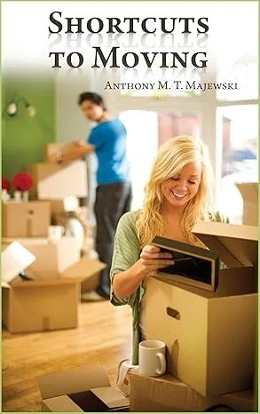 A woman smiling and packing a box in a room filled with moving supplies, with a man in the background organizing boxes.