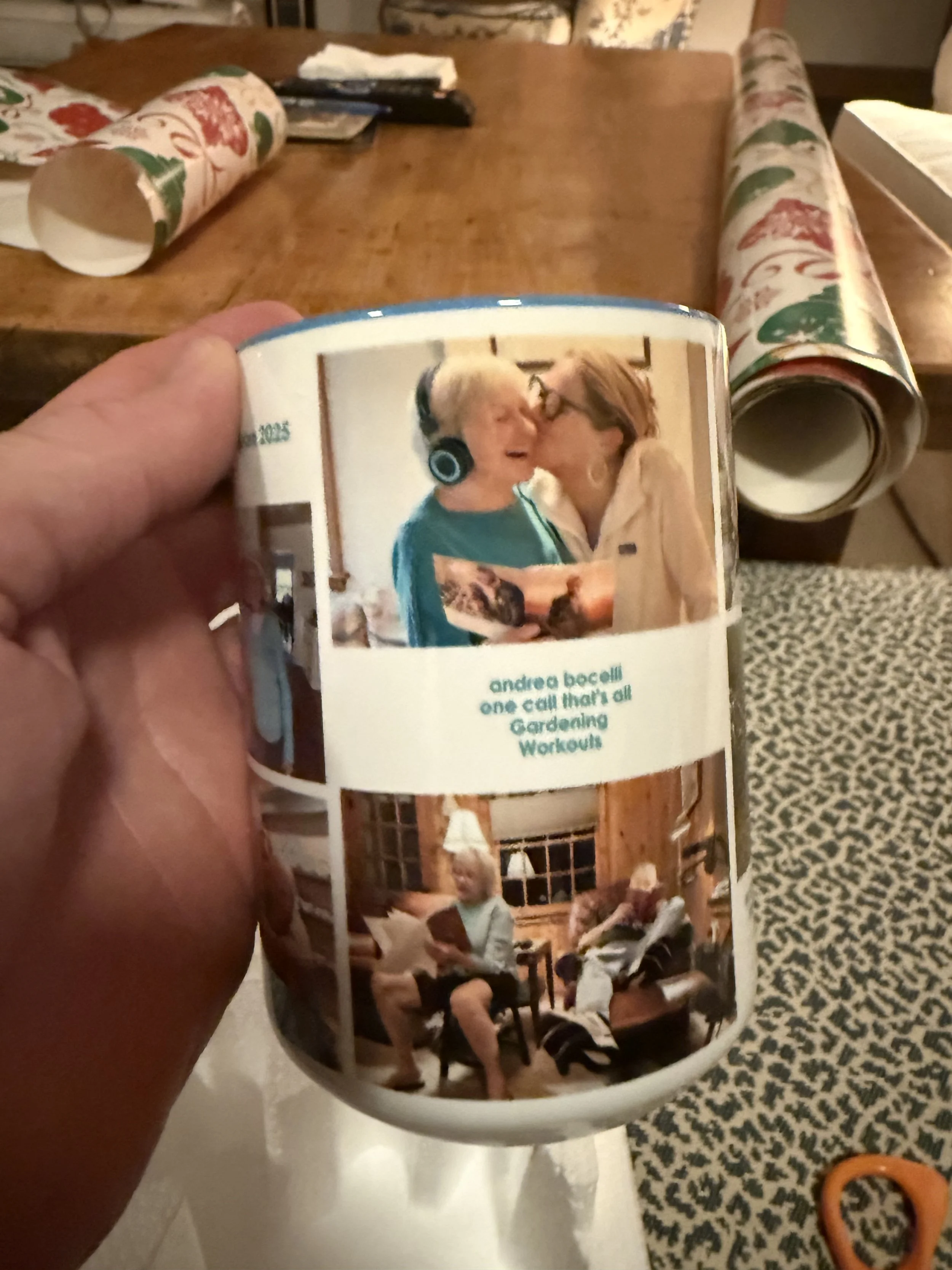 A mug with a printed photo of an elderly woman and a woman with glasses sharing a kiss, with the text: 'andrea bocelli one call that’s all Gardening Workouts'.