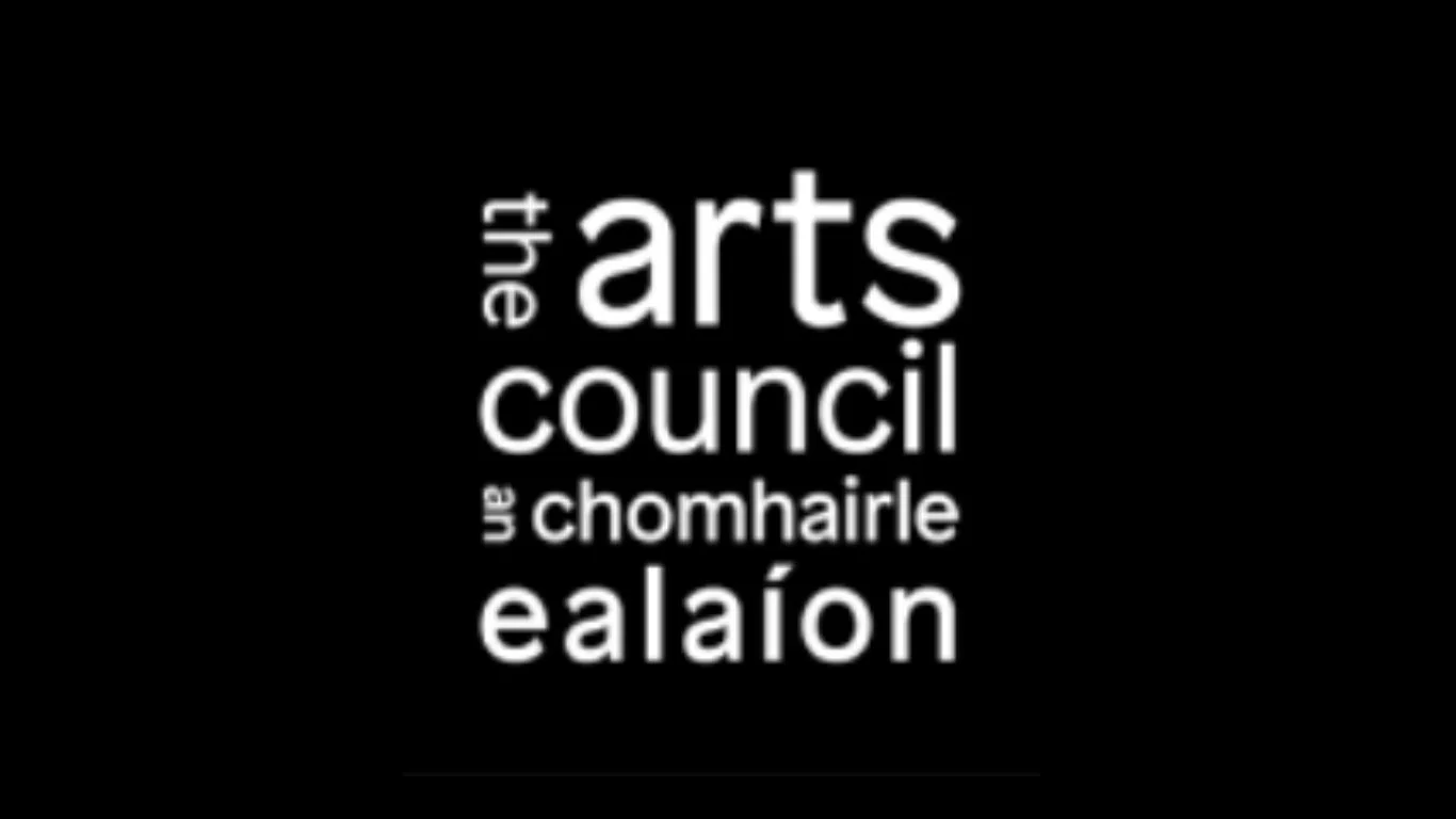 Black background with white text displaying the words "the arts council" and related terms in Gaelic.