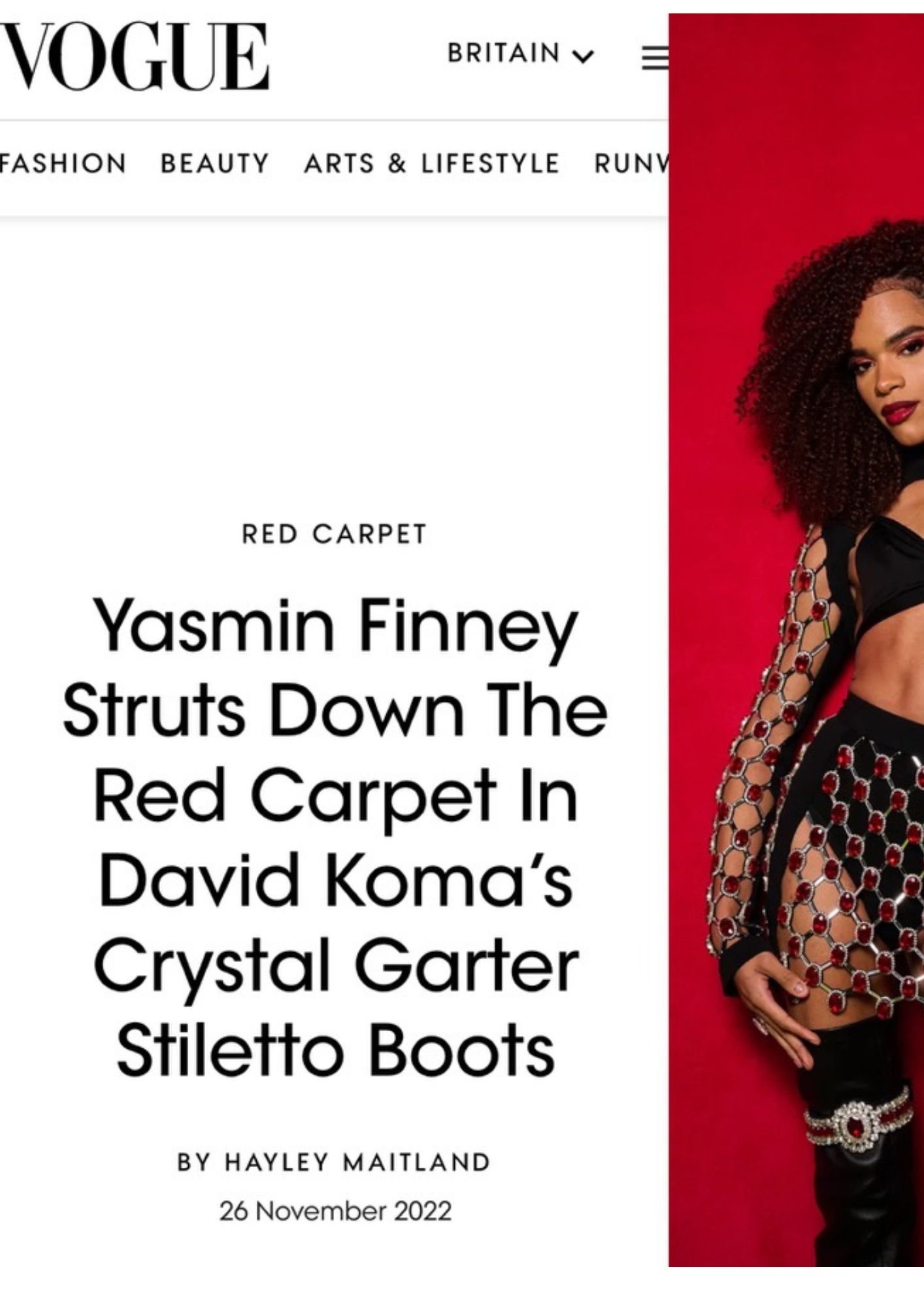 A screenshot of a Vogue article webpage titled "Yasmin Finney Struts Down The Red Carpet In David Koma's Crystal Garter Stiletto Boots," with a photo of a woman wearing a black outfit embellished with red and white crystals, standing against a red ba