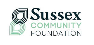 Sussex Community Foundation logo with stylized 'S' and 'C' in black and light green text.