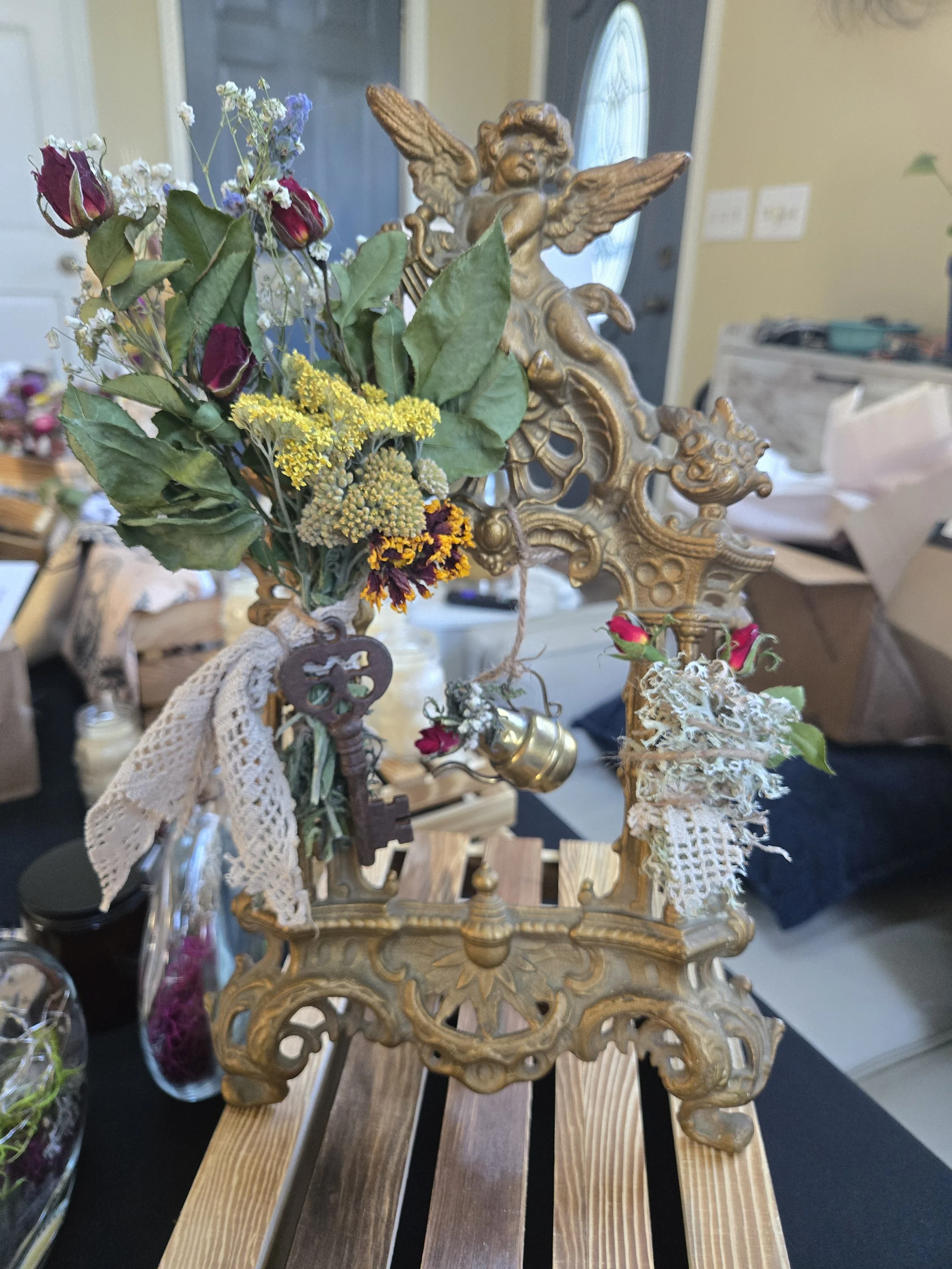 SOLD — The Cherub’s Key

A one-of-a-kind woodland art piece blending vintage keys, old lace, cherubs, roses, and found treasures into a story of hidden doors and quiet guardianship. The Cherub’s Key was created as a reminder that some doors are opene