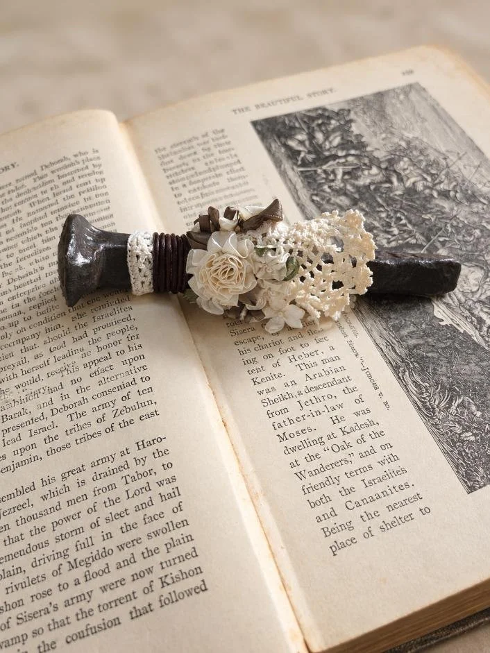 Page Keepers

Old railroad spikes softened with leather, timeworn lace, and faded ribbon work, then hand-polished with forest-scented wax. Repurposed to hold open the pages of a well-loved book.
