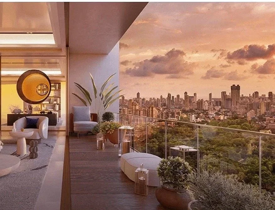 Modern balcony overlooking a city skyline at sunset, decorated with potted plants and contemporary furniture.