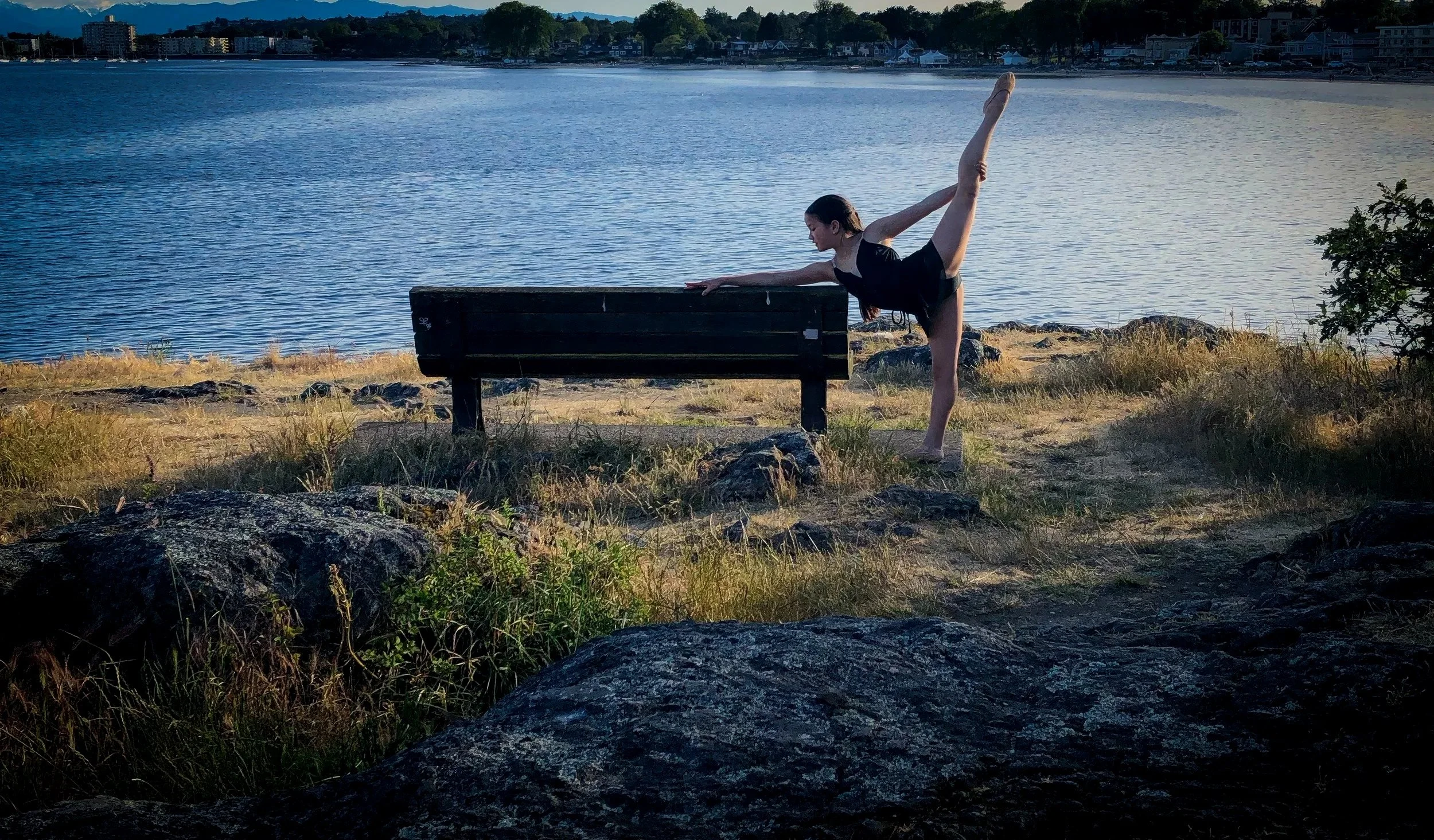 Ballet student from Prefontaine Ballet practicing an arabesque outdoors on the Vancouver waterfront, reflecting classical ballet training for dancers in North Vancouver, West Vancouver and Vancouver.