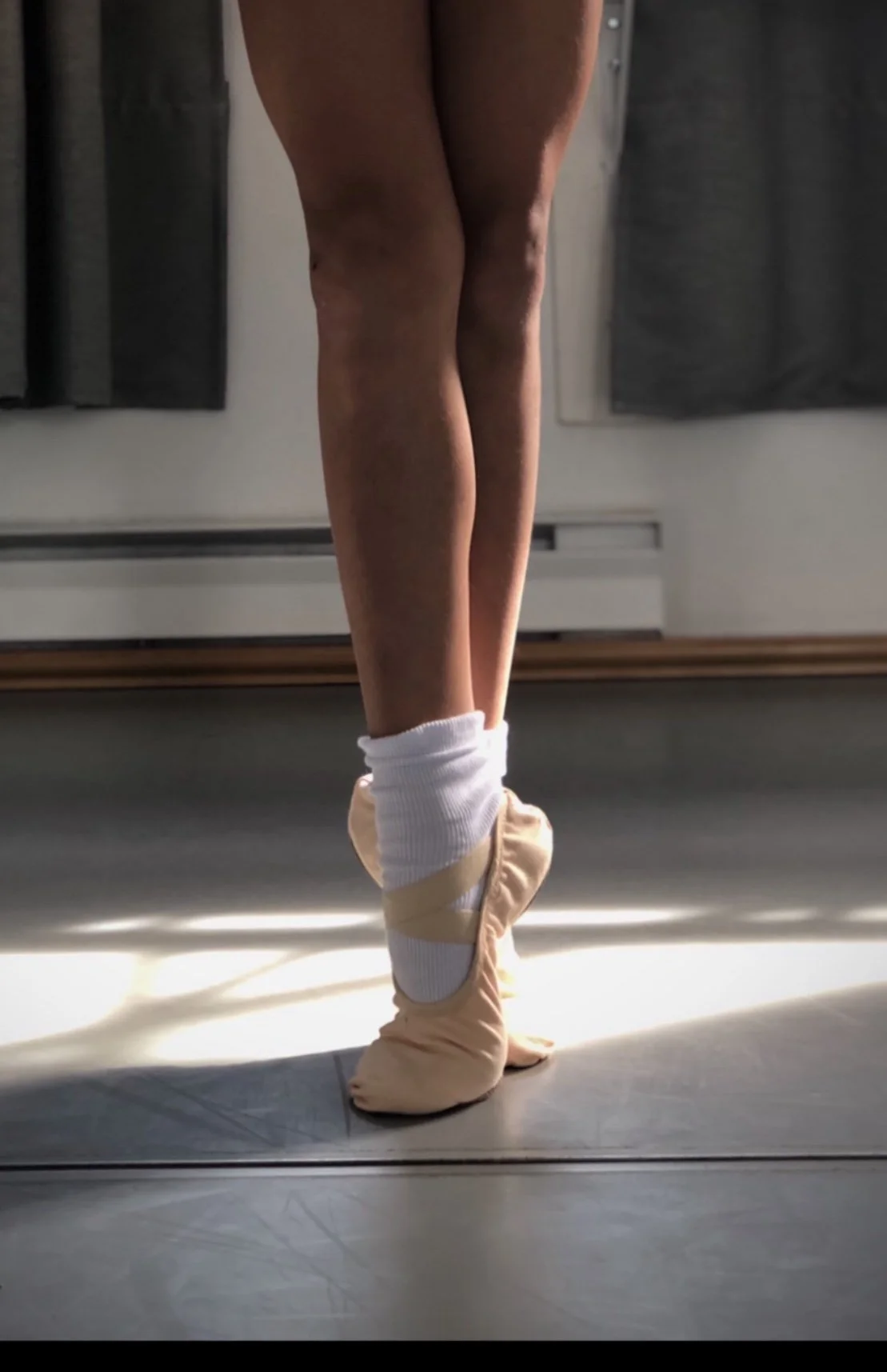 Young ballet dancer practicing pre-pointe technique to develop strength, alignment, balance, and foot stability before advancing to pointe work at Prefontaine Ballet in North Vancouver.