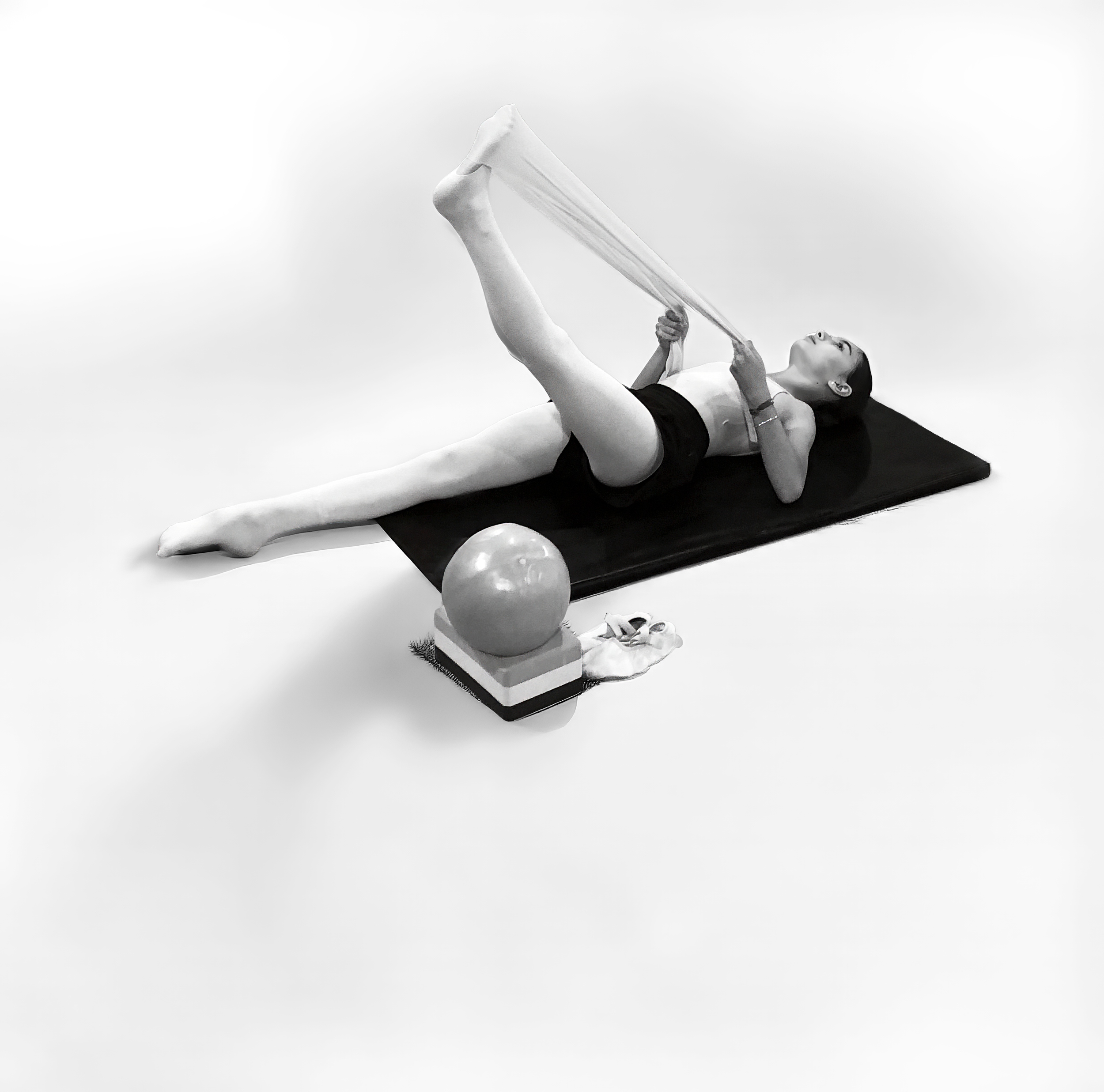 Adult participant performing a hamstring stretch during a Matwork Pilates class at Prefontaine Ballet in North Vancouver, improving flexibility, mobility, and core strength.