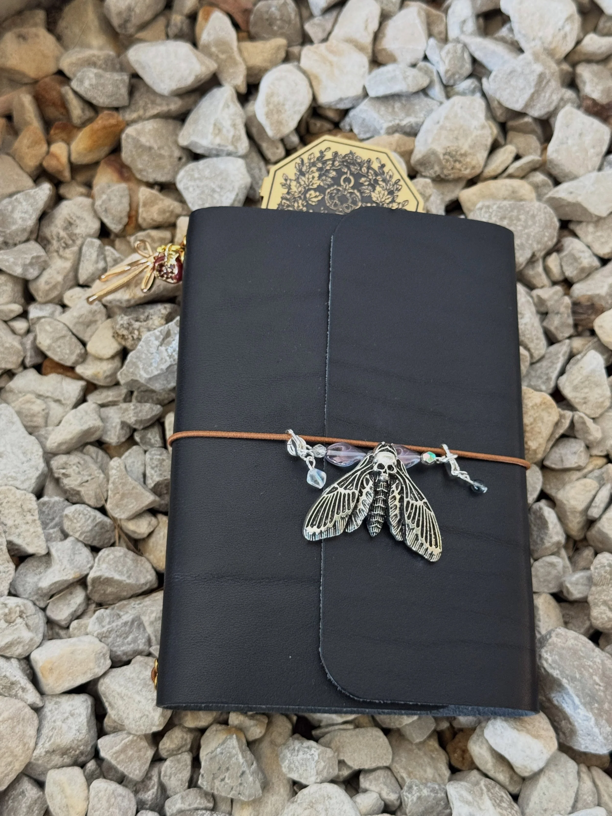 🖤❤️&zwj;🔥 Take a bite if you recognize life&rsquo;s eternal longing. Want to accessorize your @maisonrosenewyork journals to fit a theme? We got you. Peep how we bring this Hades and Persephone look to life with a mix of charms from our friends at 