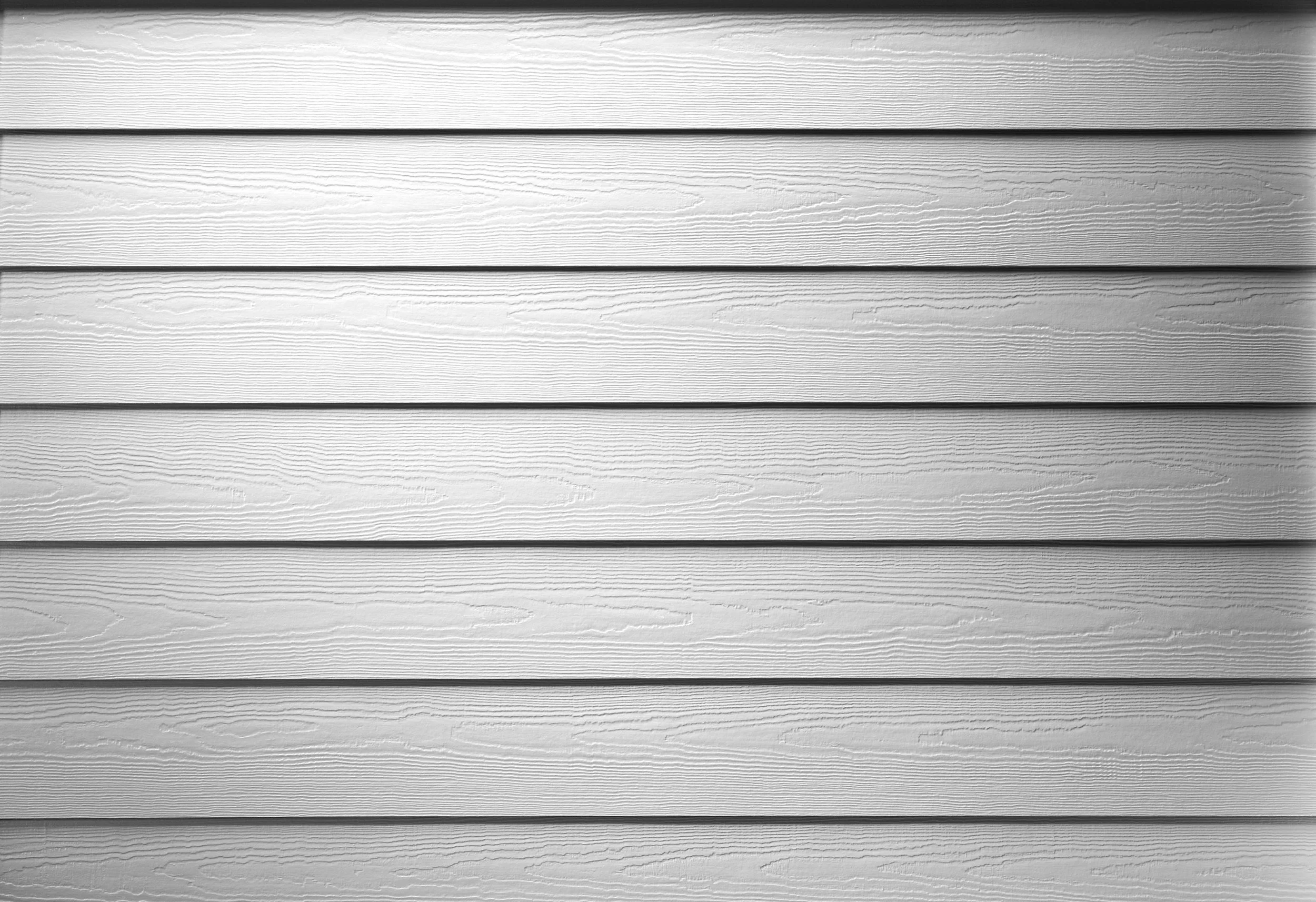 Hardie Plank lap siding with authentic cedar grain texture.