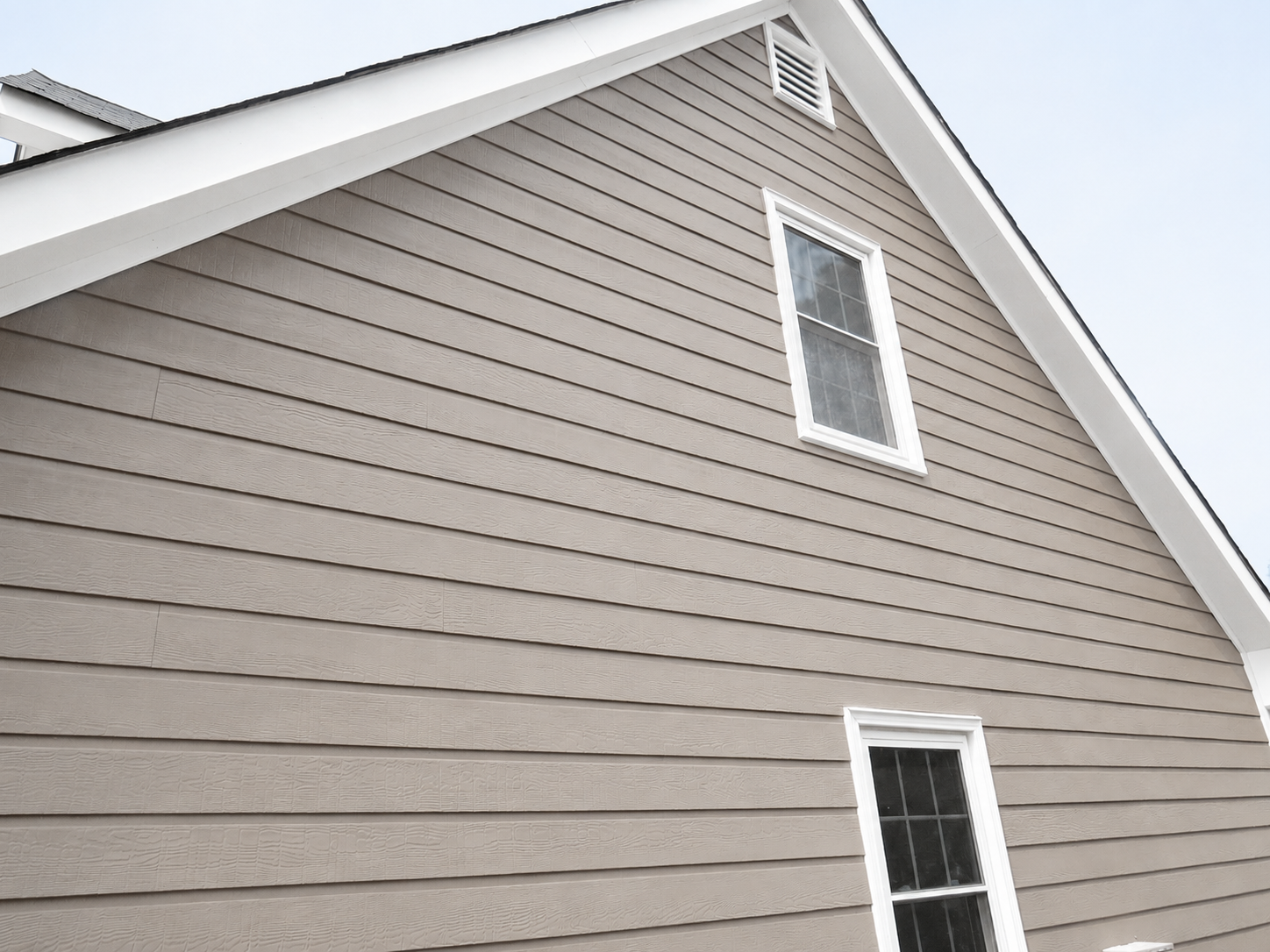 Hardie soffit integrated with fiber cement siding along a residential roof overhang.