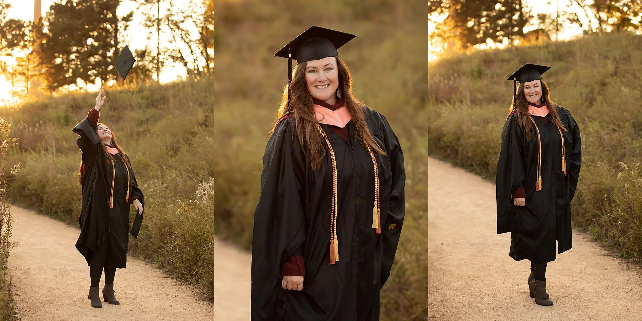 A woman in a graduation cap and gown standing outdoors on a dirt path during sunset. She is smiling, wearing a pink sash and honor cords over her gown, with one hand by her side and the other raised, tossing her cap into the air.