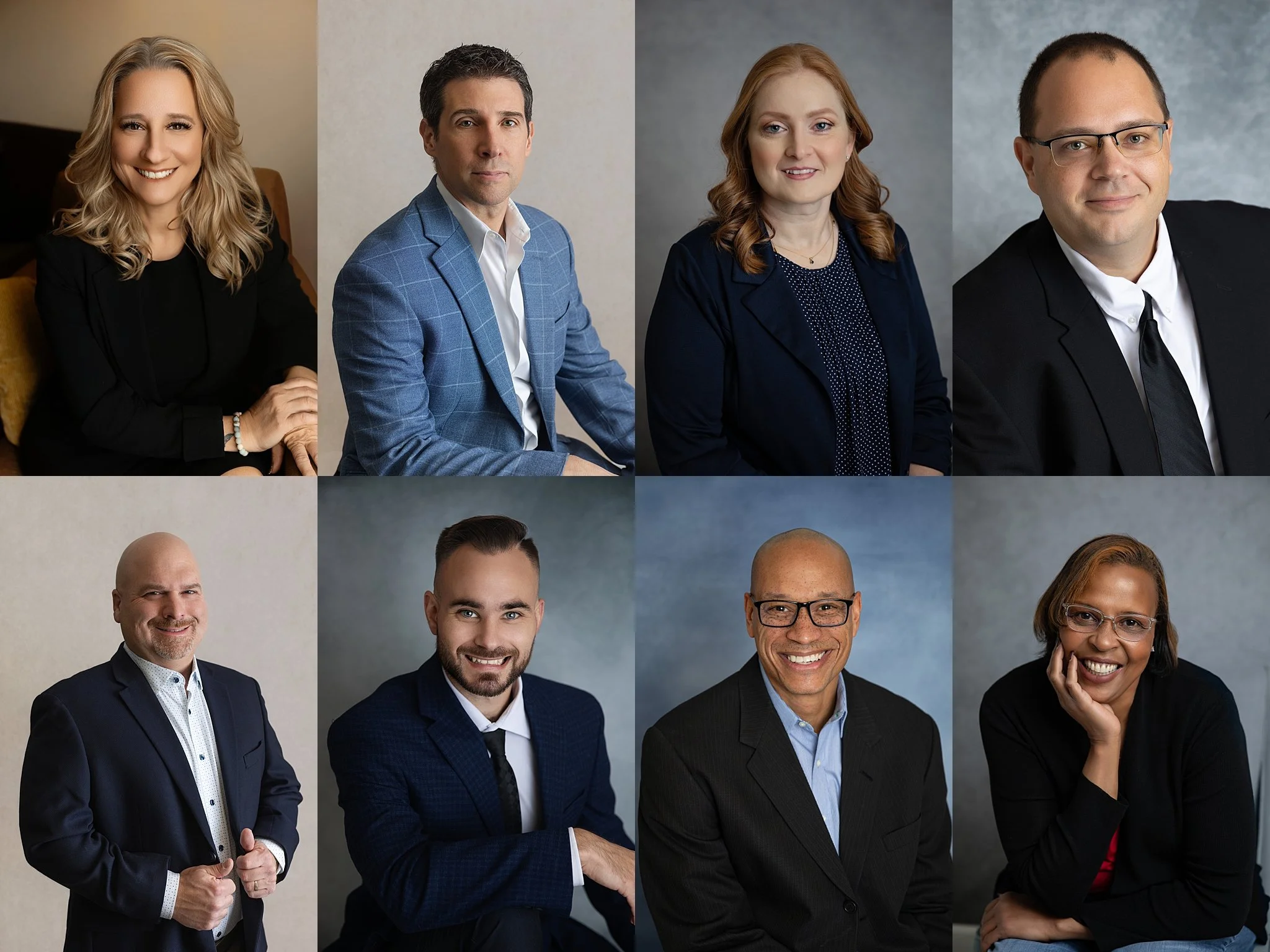 Group portrait of diverse professionals in business attire, smiling and posing for the camera.