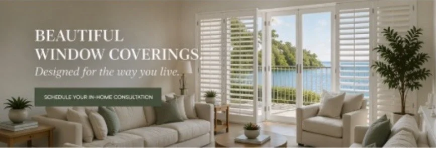 Living room with large windows and white window coverings overlooking a balcony with water view