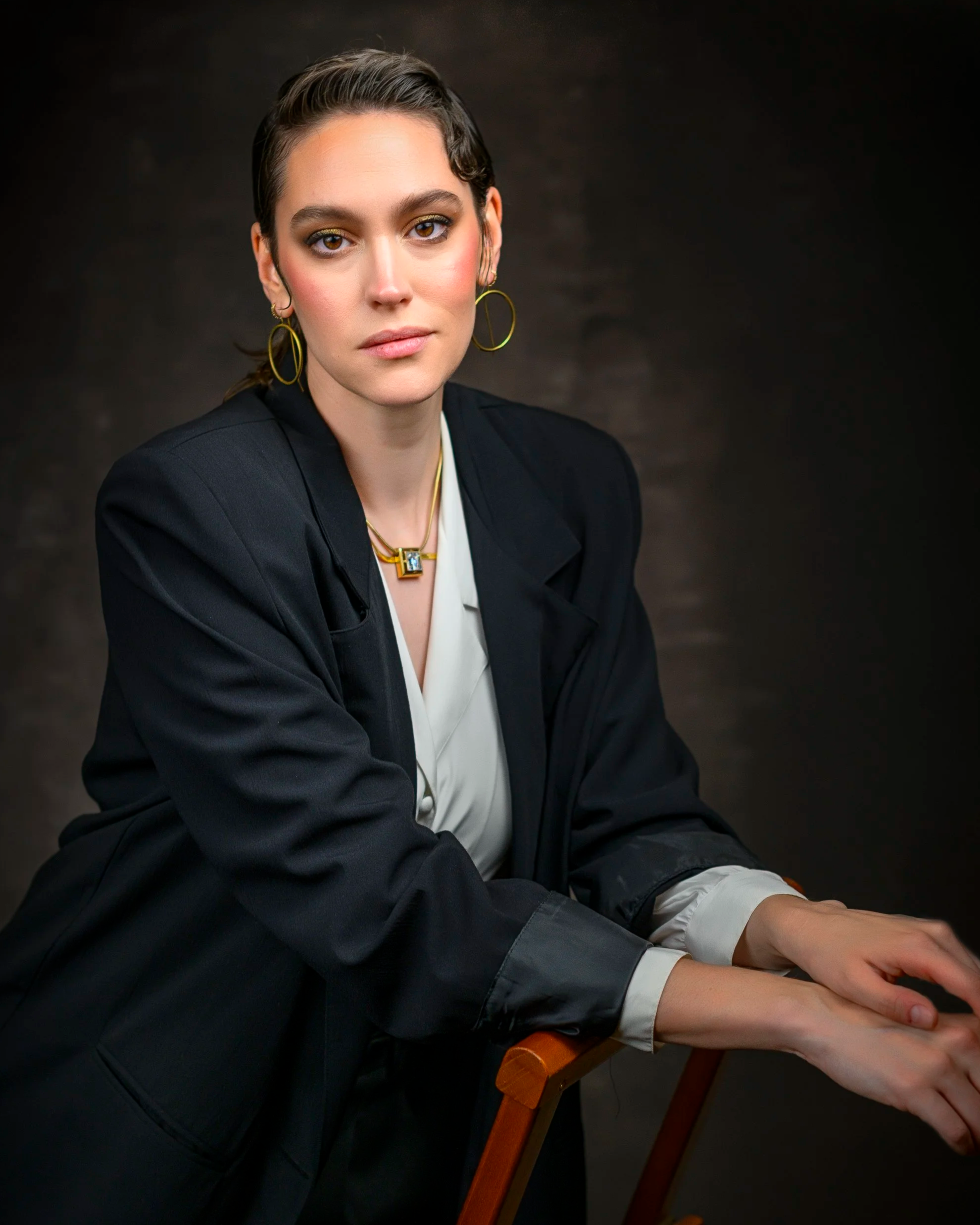 Professional portrait of a woman wearing a black blazer and white blouse.
